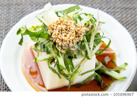 Chilled tofu with plenty of cucumbers and potherbs (myoga and perilla). Chilled tofu with plenty of cucumbers and potherbs (myoga and perilla). 105896907