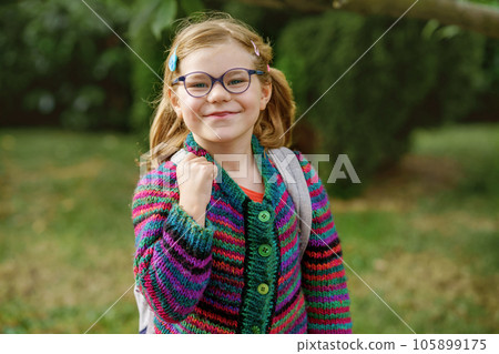 Cute little preschool girl o the way to school Healthy happy child with eyeglasses walking to nursery school and kindergarten. Smiling child with backpack on the city street, outdoors. Back to school. Cute little preschool girl o the way to school Healthy happy child with eyeglasses walking to nursery school and kindergarten. Smiling child with backpack on the city street, outdoors. Back to school. 105899175