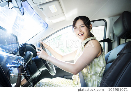 一個年輕女子開車看著相機 一個年輕女子開車看著相機 105901071