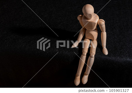 Wounded and worried drawing doll sitting down Wounded and worried drawing doll sitting down 105901327