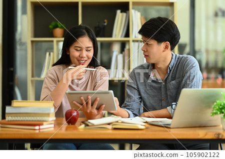 Happy college students working on project, preparing for exam together in the campus. Education and lifestyle concept 105902122