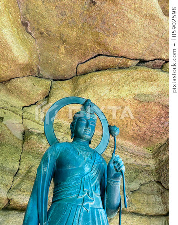 Kannon statue standing in a cave Kannon statue standing in a cave 105902598