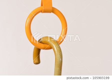 Umbrella handle hanging on a strap 105903199