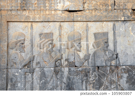 Ancient wall with bas-relief with four assyrian warriors with spears, Persepolis, Iran. UNESCO world heritage site 105903807