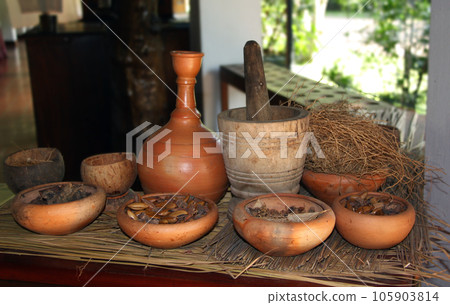 Clay jug and bowls with natural ingredient of ayurvedic treatment, Sri Lanka. Herbal treatment concept Clay jug and bowls with natural ingredient of ayurvedic treatment, Sri Lanka. Herbal treatment concept 105903814