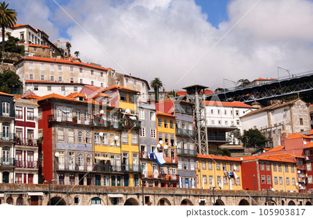 Embankment in Old Porto district, Porto, Portugal. Front view of historical center with colorful medieval houses of Oporto city, Ribeira. View from Douro river Embankment in Old Porto district, Porto, Portugal. Front view of historical center with colorful medieval houses of Oporto city, Ribeira. View from Douro river 105903817