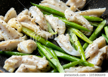 A cooking scene in which chicken cartilage (Yagen cartilage) and garlic sprouts are fried in a frying pan. 105906849
