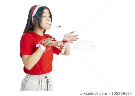Indonesian girl celebrate Indonesian independence day on 17 August with a marbles race using a spoon 105909154