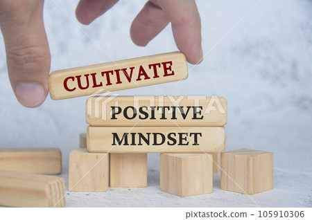 Cultivate positive mindset text on wooden blocks. Continuous improvement concept Cultivate positive mindset text on wooden blocks. Continuous improvement concept 105910306