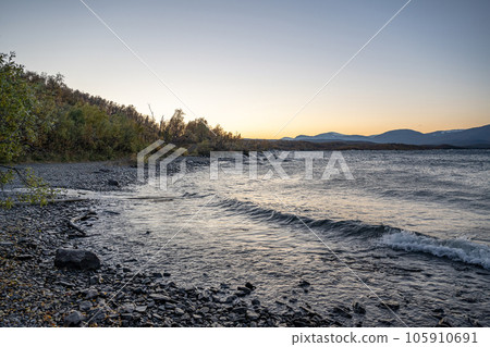 Sunset Autumn season in Abisko with Lake Tornetraesk in background, taken from Bjoerkliden, Swedish Lapland, Sweden 105910691