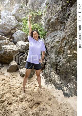 Asian woman with an excited expression traveling on the beach Asian woman with an excited expression traveling on the beach 105910797