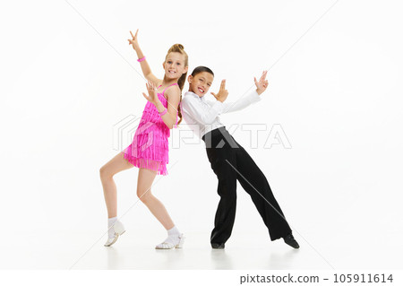 Beautiful, stylish children boy and girl dancing retro style dance, performing against white studio background Beautiful, stylish children boy and girl dancing retro style dance, performing against white studio background 105911614