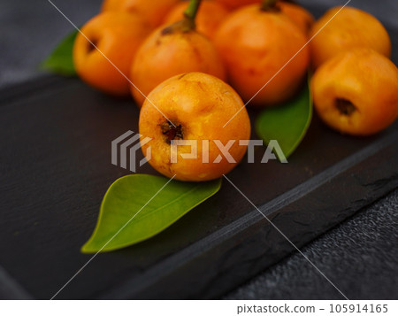 Loquat Medlar fruit isolated on dark table background Loquat Medlar fruit isolated on dark table background 105914165