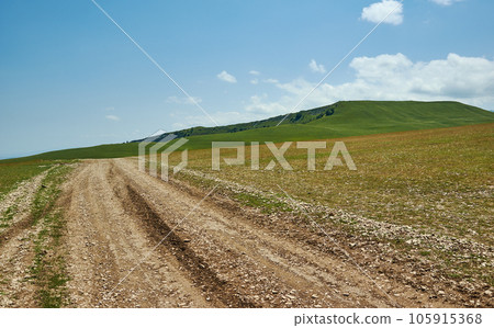 Scenic view of green meadows big mountain Dagestan Scenic view of green meadows big mountain Dagestan 105915368