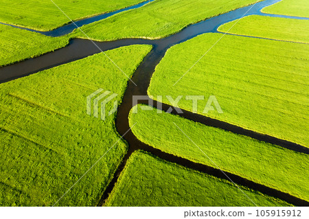 Aerial view of green field. Netherlands. Canals with water for agriculture. Aerial view of green field. Netherlands. Canals with water for agriculture. 105915912