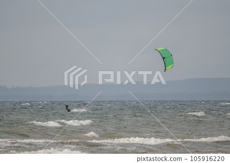 Melbystrand Sweden A kitesurfer practise his surfing skills close to beach with sand dunes Melbystrand Sweden A kitesurfer practise his surfing skills close to beach with sand dunes 105916220