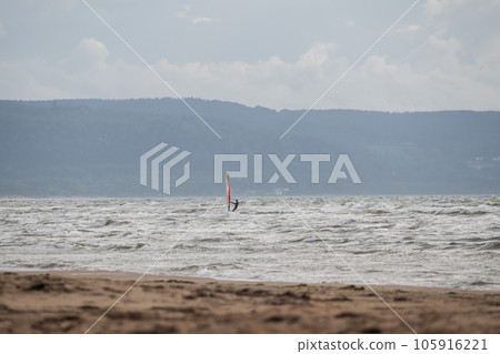 Melbystrand Sweden A windsurfer practise his surfing skills close to beach with sand dunes 105916221