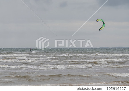 Melbystrand Sweden A kitesurfer practise his surfing skills close to beach with sand dunes Melbystrand Sweden A kitesurfer practise his surfing skills close to beach with sand dunes 105916227