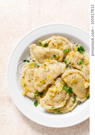 Homemade pierogi, dumplings, varenyky or vareniki with cabbage, top view 105917612
