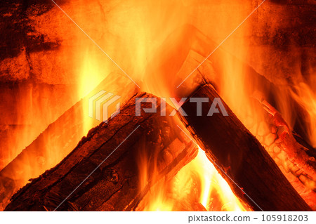Wood burning in fireplace. Fire keep warm. Crest of flame on burning wood in fireplace. Soft focus. Blurry focus 105918203
