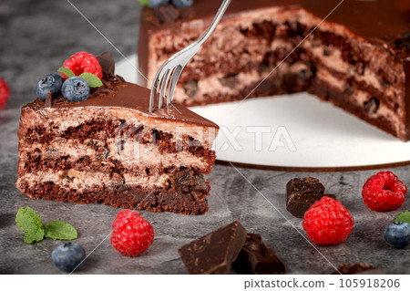 Prune cake. Homemade cake with prunes and walnuts on a gray background. Close-up Prune cake. Homemade cake with prunes and walnuts on a gray background. Close-up 105918206