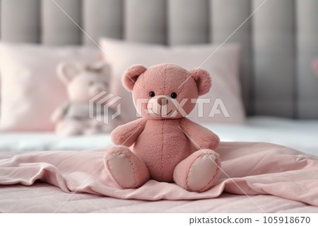 Teddy bear sitting on the bed Teddy bear sitting on the bed 105918670