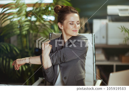 happy business woman in green office stretching hands 105919583