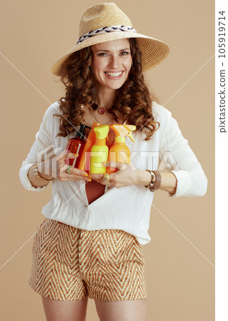 happy elegant woman in blouse and shorts on beige happy elegant woman in blouse and shorts on beige 105919714