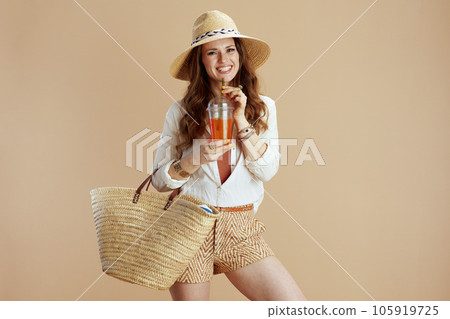 happy elegant woman in blouse and shorts isolated on beige happy elegant woman in blouse and shorts isolated on beige 105919725