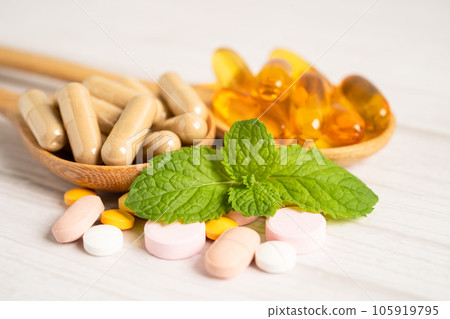 Alternative medicine herbal organic capsule with vitamin E omega 3 fish oil, mineral, drug with herbs leaf natural supplements for healthy good life. Alternative medicine herbal organic capsule with vitamin E omega 3 fish oil, mineral, drug with herbs leaf natural supplements for healthy good life. 105919795