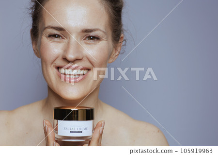 happy modern 40 years old woman with cosmetic cream jar happy modern 40 years old woman with cosmetic cream jar 105919963