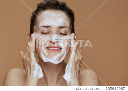 happy young female with foaming face wash washing face 105919967