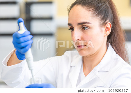 Young woman scientist in a research laboratory creating a scientific experiment, laboratory concept 105920217