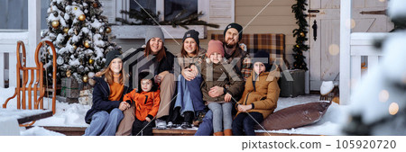 A large family sits on the porch for christmas 105920720