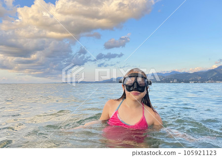Young girl with mask exploring underwater. Kids snorkel swimming. Snorkeling diving child. 105921123