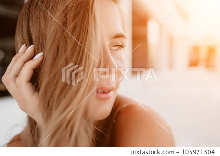 Happy woman portrait in cafe. Boho chic fashion style. Outdoor photo of young happy woman with long hair, sunny weather outdoors sitting in modern cafe. Happy woman portrait in cafe. Boho chic fashion style. Outdoor photo of young happy woman with long hair, sunny weather outdoors sitting in modern cafe. 105921304