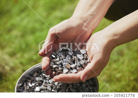 Ukrainian volunteer holding homemade shrapnel to make bombs Ukrainian volunteer holding homemade shrapnel to make bombs 105921778