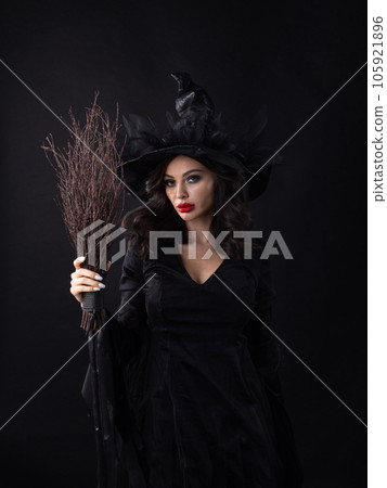 Charming halloween witch with broom 105921896