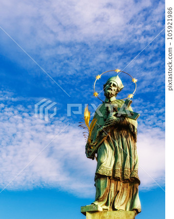 Statue of John of Nepomuk on Charles Bridge in Prague against the sky. 105921986