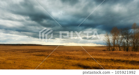 Dramatic sky over the autumn field. Evening landscape. Dramatic sky over the autumn field. Evening landscape. 105921992