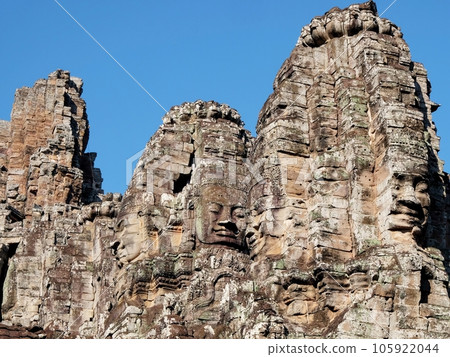 Image showcasing stone human faces on the towers of the Khmer Bayon Temple in Cambodia. Image showcasing stone human faces on the towers of the Khmer Bayon Temple in Cambodia. 105922044