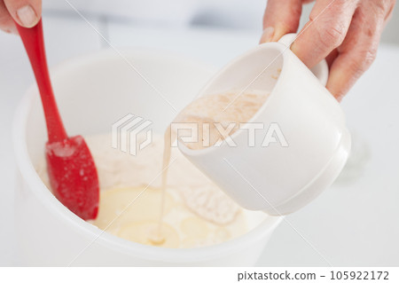 Adding leavened yeast. Home made pizza dough preparation. Pizza preparation. Adding leavened yeast. Home made pizza dough preparation. Pizza preparation. 105922172