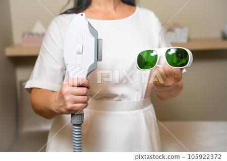 Laser epilation and cosmetology in beauty salon. Hair removal laser epilation and protective goggles Laser epilation and cosmetology in beauty salon. Hair removal laser epilation and protective goggles 105922372