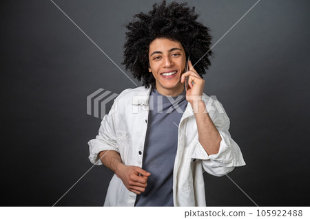 Man in white shirt talking on the phone and smiling 105922488