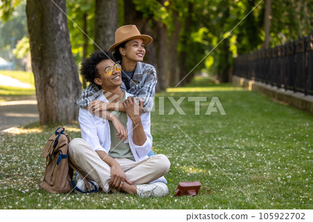 Young couple looking happy while spending time together in the park Young couple looking happy while spending time together in the park 105922702