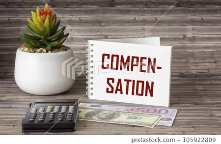 The word COMPENSATION is written on a notepad. Euro and dollar banknotes, calculator and cactus lie The word COMPENSATION is written on a notepad. Euro and dollar banknotes, calculator and cactus lie 105922809