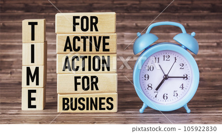 text TIME FOR ACTIVE ACTION FOR BUSINESS, concept on wooden blocks, near an alarm clock 105922830