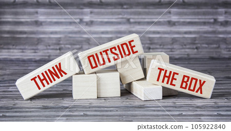 Think outside the box inspirational motivational quotes on wooden blocks and gray background 105922840