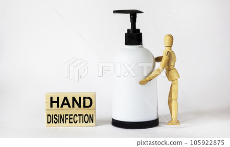 Hand disinfection, text is written on wooden blocks.Wooden doll with alcohol spray  105922875