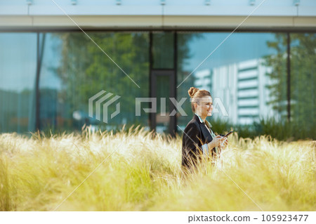 happy modern woman employee near office building happy modern woman employee near office building 105923477